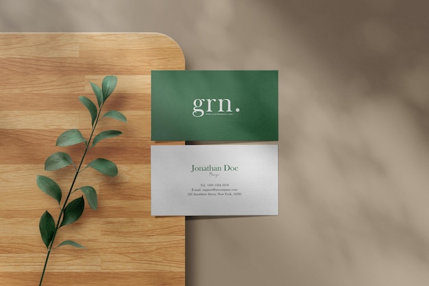 Clean minimal business card mockup on wooden plate  