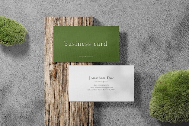 Clean minimal business card mockup on wooden with moss background