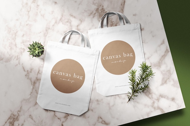 Clean minimal canvas bag mockup on top marble with plant and conifer background. PSD file.