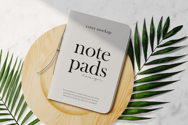 Clean minimal cover notepads mockup on wooden plate with leaves