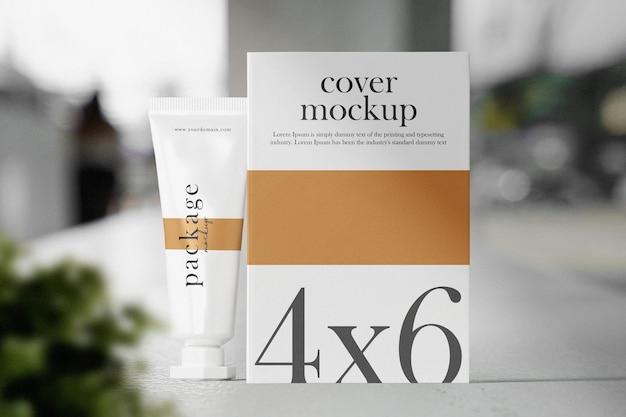 Clean minimal cream tube packaging and book 4x6 mockup on cafe background with plant foreground