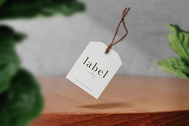 Clean minimal label mockup floating on top table with plant foreground