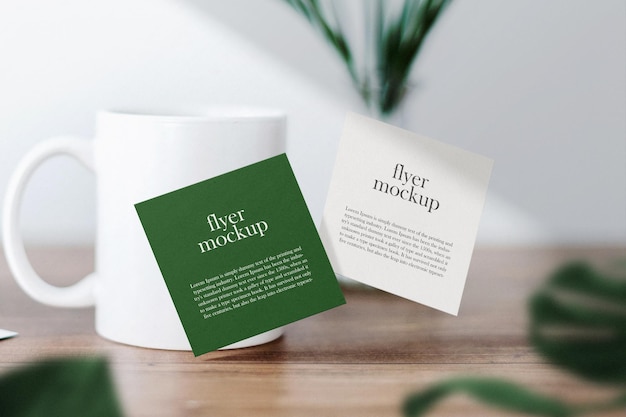 Clean minimal square flyer mockup floating on top table with cub and leaves. 