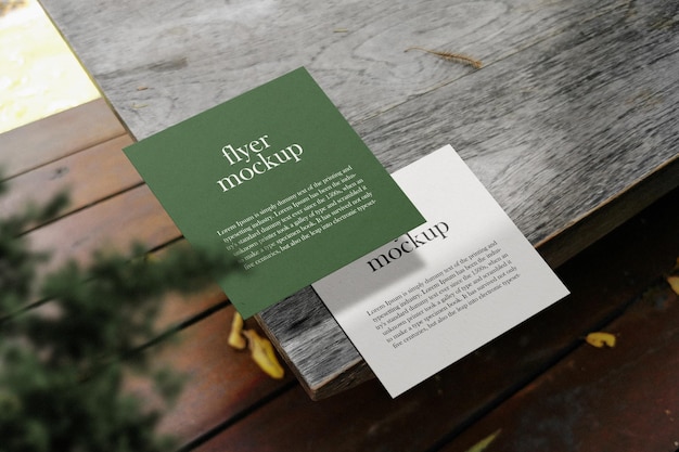 Clean minimal square flyer mockup on top wooden with plant PSD file