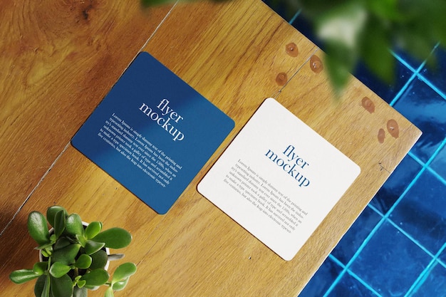 Clean minimal square flyer mockup on top wooden with plant