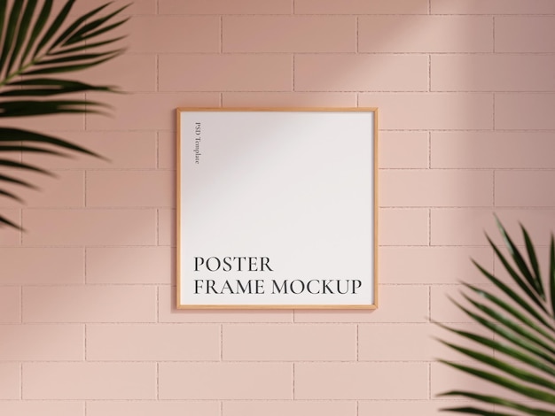 Clean and minimalist front view square wooden photo or poster frame mockup hanging on the brick wall with blurry plant 3d rendering