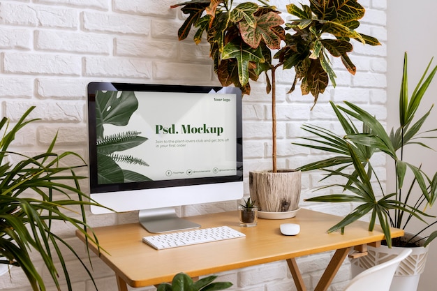 Close up on computer mockup surrounded by plants