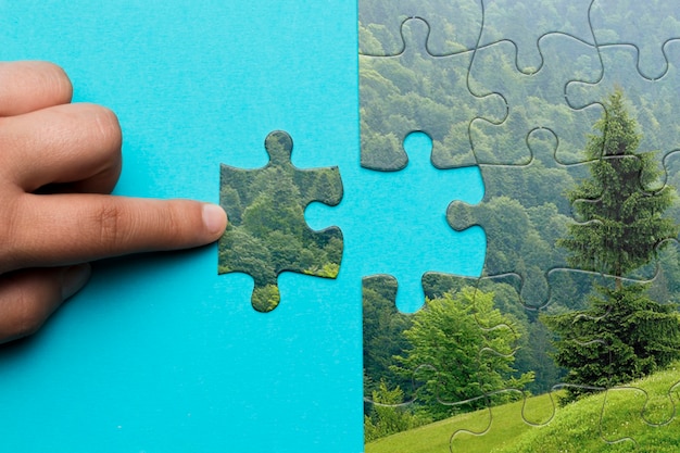 Close-up man making a puzzle