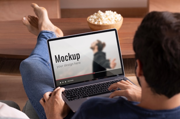 Close up man watching movie on laptop