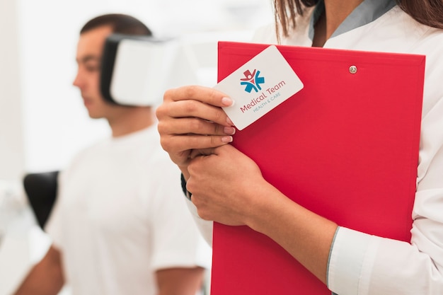 Close-up mock-up clinical card and man doing medical exercises