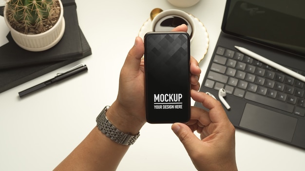 Close up view of male hands holding smartphone mockup