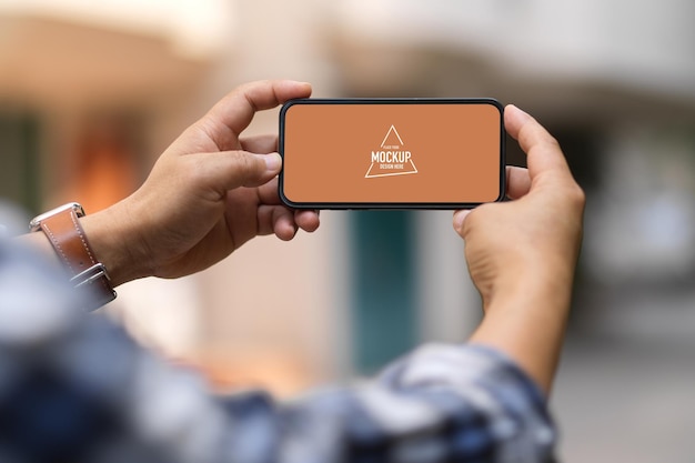 Close up view of a man hands holding smartphone mockup