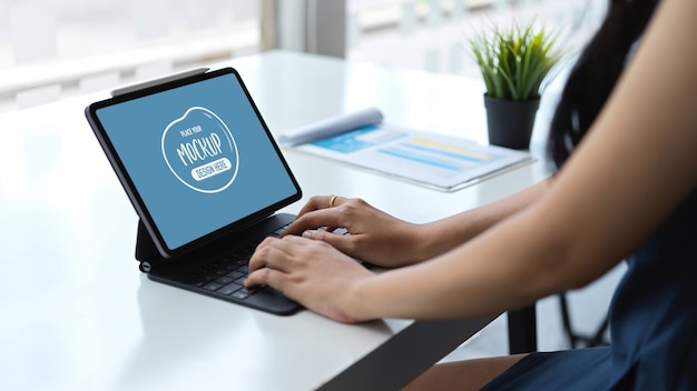 Close up view of young businesswoman typing on laptop mockup