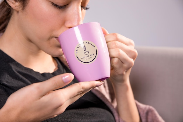 Close-up woman drinking from pink mug