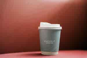 PSD coffee cup mockup in a red backdrop