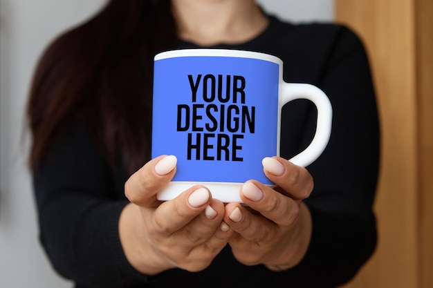 Coffee mug in women's hands closeup mockup changeable color psd