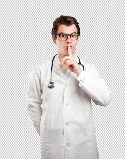 Confident doctor with silence gesture against white background