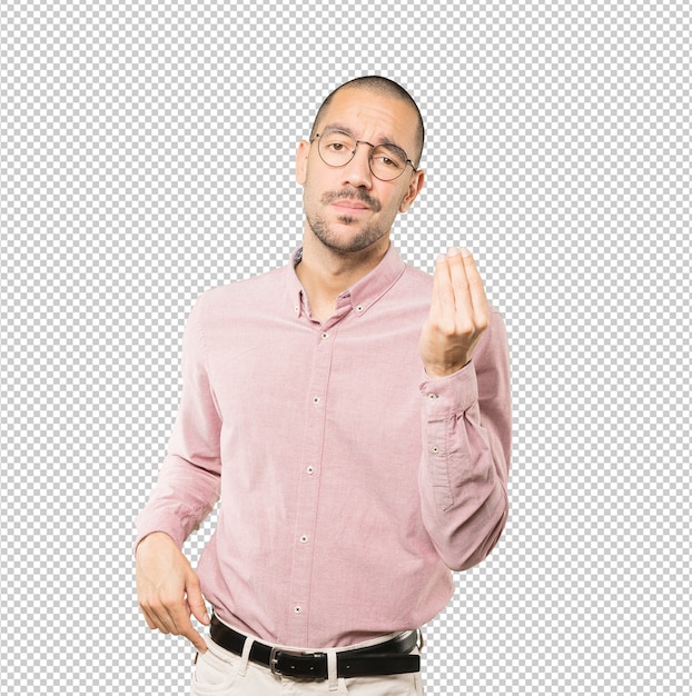 Confused young man making an italian gesture of not understand