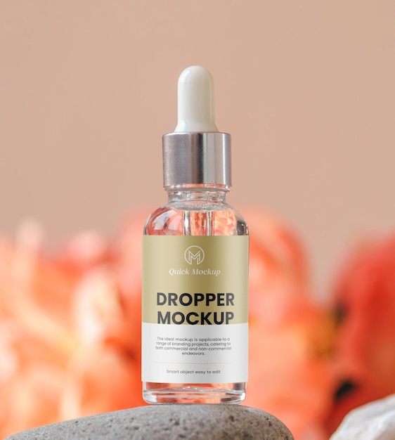 PSD cosmetic clear glass dropper bottle on stone podium with peonies in soft focus natural beauty product