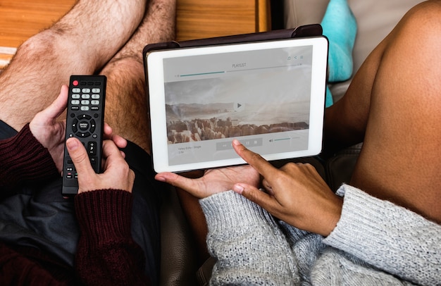 PSD couple checking music playlist on tablet