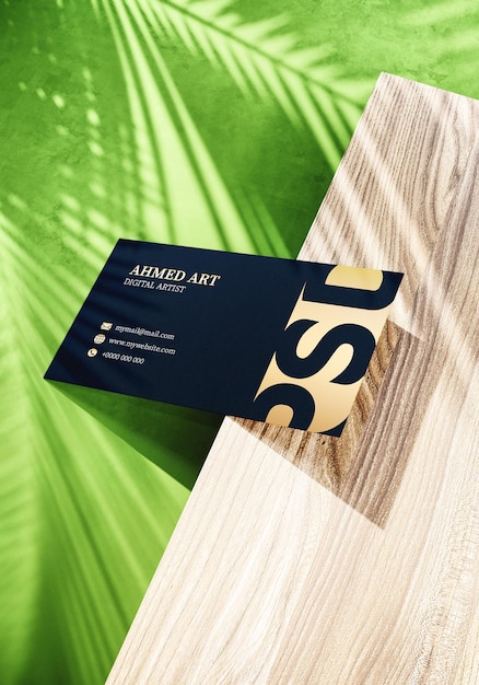 Creative business card on wooden piece with palm shadows mockup