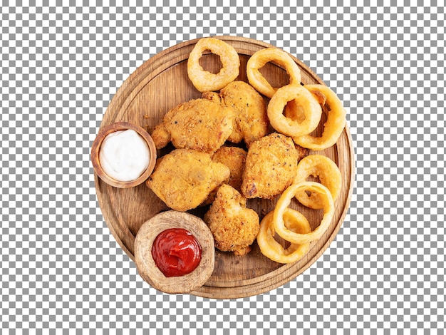 Crispy fried chicken nuggets with onion rings and sauces on wooden plate with transparent background