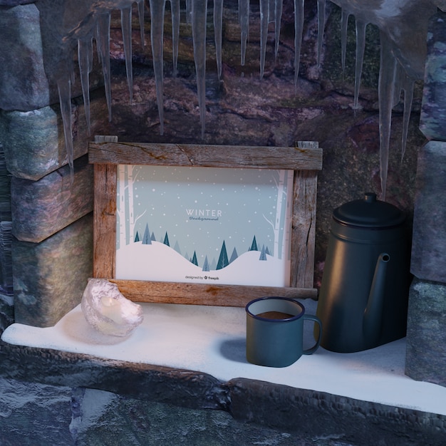 Cup with tea beside winter frame