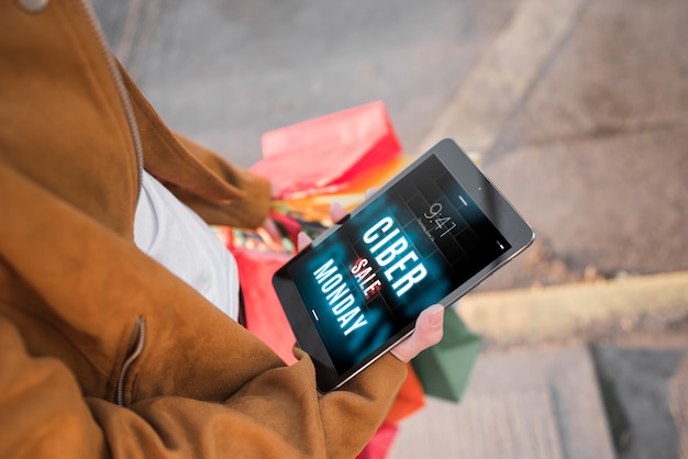 Cyber monday mockup with woman holding tablet