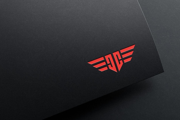 Debossed logo mockup on dark paper