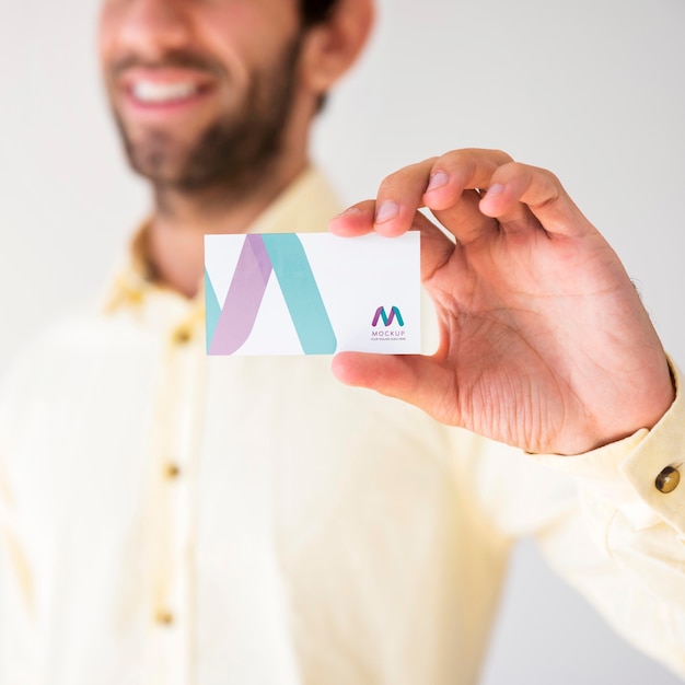 Defocused businessman holding up businesscard