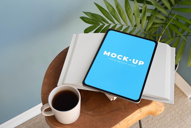 PSD digital book tablet mockup with cup of coffee and plant cozy home