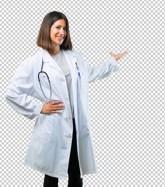 Doctor woman with stethoscope pointing back with the index finger presenting a product