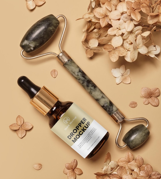 PSD dropper glass bottle mockup face roller and dry flowers on beige background natural skincare beauty product