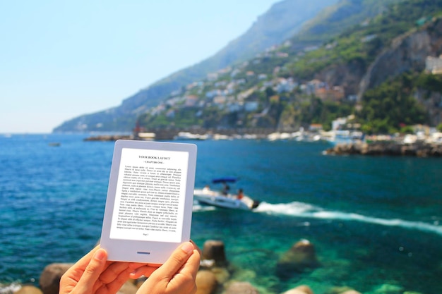 PSD e-book reader, mock-up, blue sea background with boat