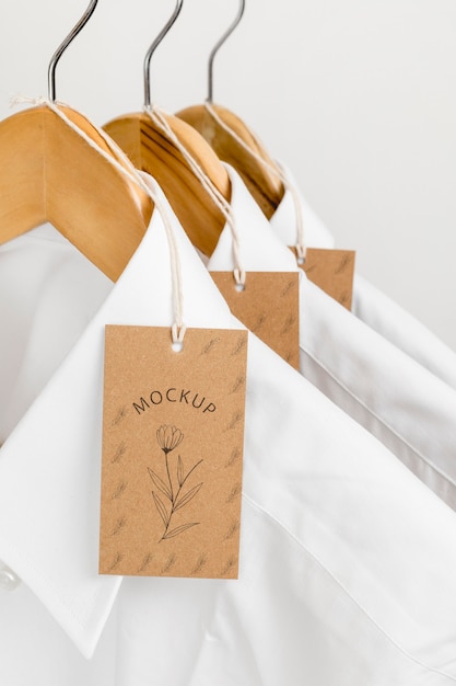 Eco-friendly price tags and formal shirts with hangers mock-up