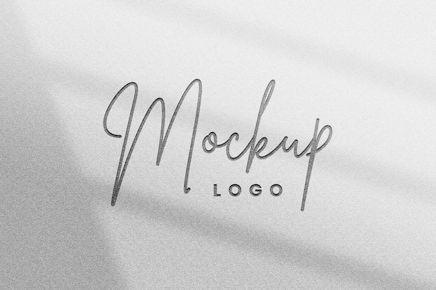 Editable metallic business logo mockup psd in embossed style