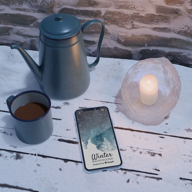 Electronic device beside kettle with tea