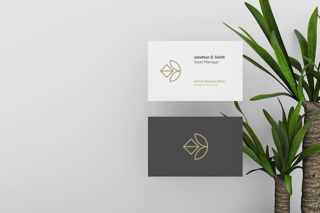 Elegant dark and white business card mockup with plants as background