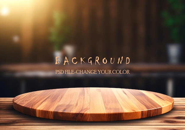 Empty wooden table with green leaves on the background