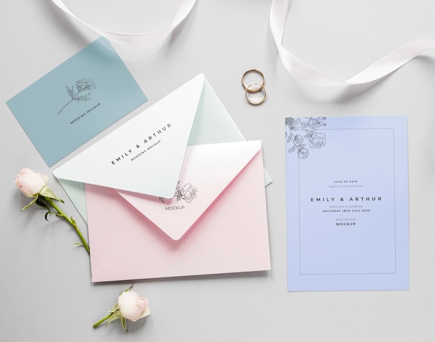 Fat lay of wedding card with envelopes and roses