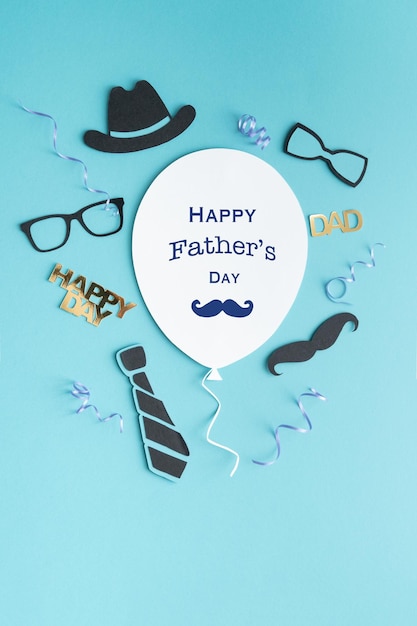 Father's Day greeting balloon card with decoration on blue background Copy space Vertical photo