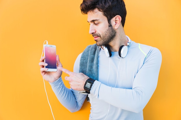 Fitness mockup with man showing smartphone