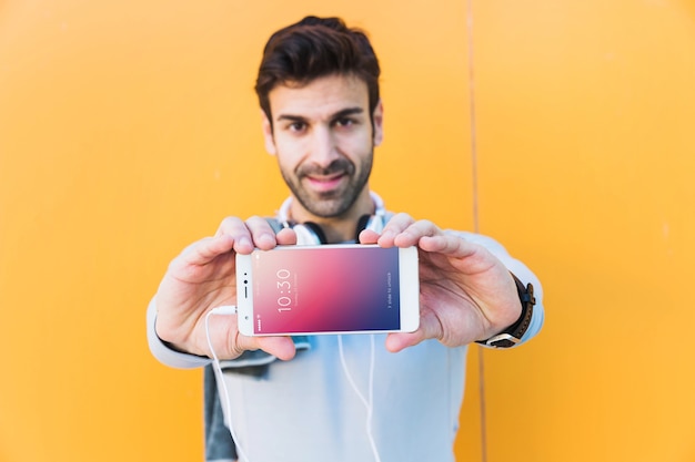 Fitness mockup with man showing smartphone