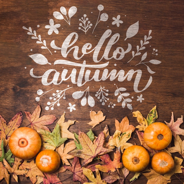 Flat lay autumn leaves on wooden background