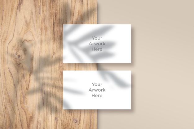 Flat Lay Business Card  Mockup with leaves shadow on wooden Piece