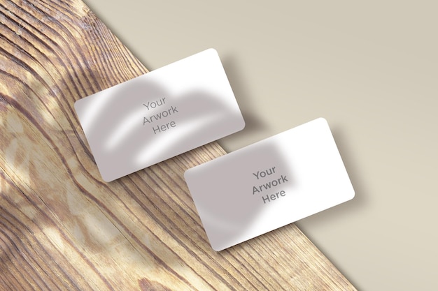 Flat Lay Business Card  Mockup with leaves shadow on wooden Piece