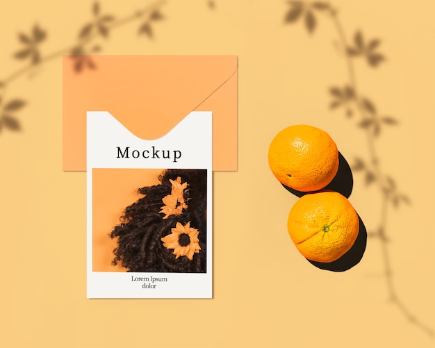 Flat lay of card with citrus and leaves shadow