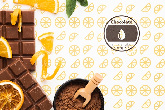 Flat lay chocolate with orange background mock-up