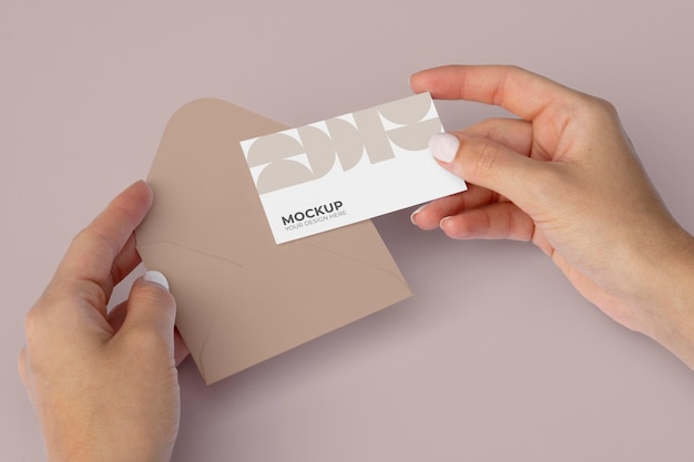 Flat lay close up hands holding business card