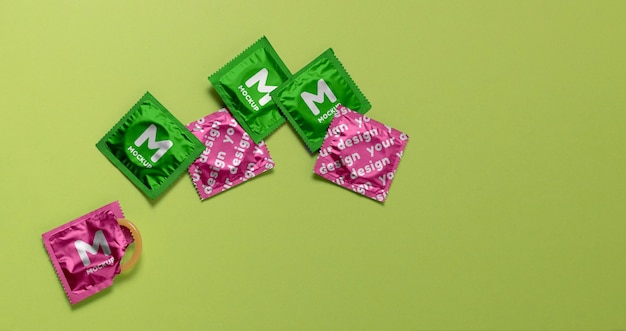 Flat lay condoms on green background